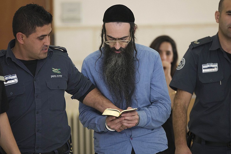 
              Yishai Schlissel, who fatally stabbed a teenage girl and wounded others at last year Jerusalem's gay pride parade, reads scripture at court in Jerusalem, Tuesday, April 19, 2016. The District Court convicted Schlissel for murder for last year’s deadly attack, along with multiple attempted murder charges for those he wounded. (AP Photo/Oded Balilty)
            