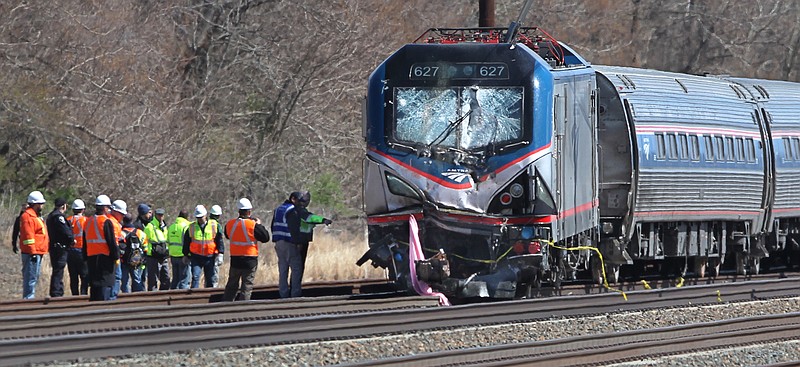 
              FILE - In this Sunday, April 3, 2016, file photo, Amtrak investigators inspect a deadly train crash in Chester, Pa. Federal crash investigators said on Monday, April 18, 2016, that a backhoe operator had a right to be on the train tracks periodically on the weekend the train slammed into the maintenance equipment, killing the operator and a supervisor. (Michael Bryant/The Philadelphia Inquirer via AP, File)  PHIX OUT; TV OUT; MAGS OUT; NEWARK OUT; MANDATORY CREDIT
            