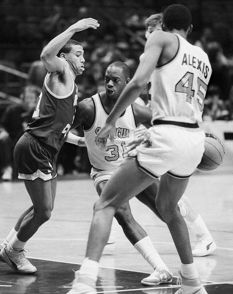 
              FILE - In this March 6, 1986 file photo, Dwayne "Pearl" Washington (31) of Syracuse University drives around Dana Barros (21) of Boston College during the Big East tournament at New York's Madison Square Garden. Washington, who went from New York City playground wonder to Big East star for Jim Boeheim at Syracuse, has died. He was 52. Washington died Wednesday, April 20, 2015 of cancer, the university said. (AP Photo/Richard Drew, File)
            