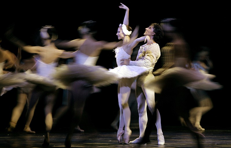 
              FILE - In this file photo dated Sunday Sept. 23, 2007, Ballet dancers Julio Bocca, right, and Alina Cojocaru perform Swan Lake in Buenos Aires, Argentina, Sunday Sept. 23, 2007.  Romania Opera house artistic director Johan Kobborg, of Denmark, has resigned, and it is announced Thursday April 14, 2016, that Romania's Prime Minister Dacian Ciolos intends to help find a solution to a bitter dispute raging at the Romanian Opera.  Ciolos decided to step in to the dispute after his meeting with internationally renowned ballerina Alina Cojocaru who says she won't dance Manon this weekend and claims there is an atmosphere of "fear and intimidation."  (AP Photo/Natacha Pisarenko, FILE)
            
