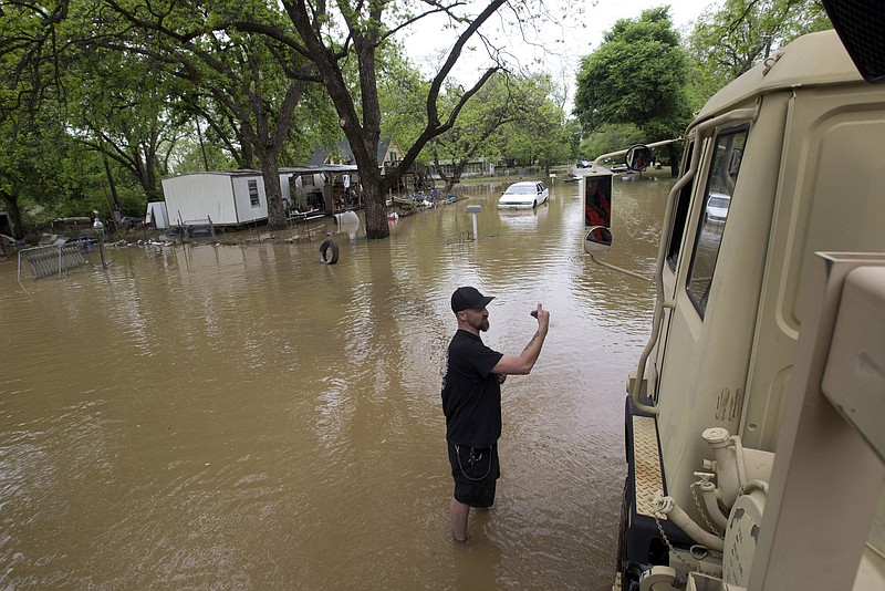 
              The Army National Guard high profile vehicles (HPV) allowed volunteer firefighters/swift water rescuers from Springcreek Volunteer FD station 3 in Horseshoe Bend, Texas, to check on the welfare of residents who decided to stay in their homes during the  Brazos river flooding in the Horseshoe Bend area of Parker County on Tuesday, April 19,  2016. (Joyce Marshall/Star-Telegram via AP)
            
