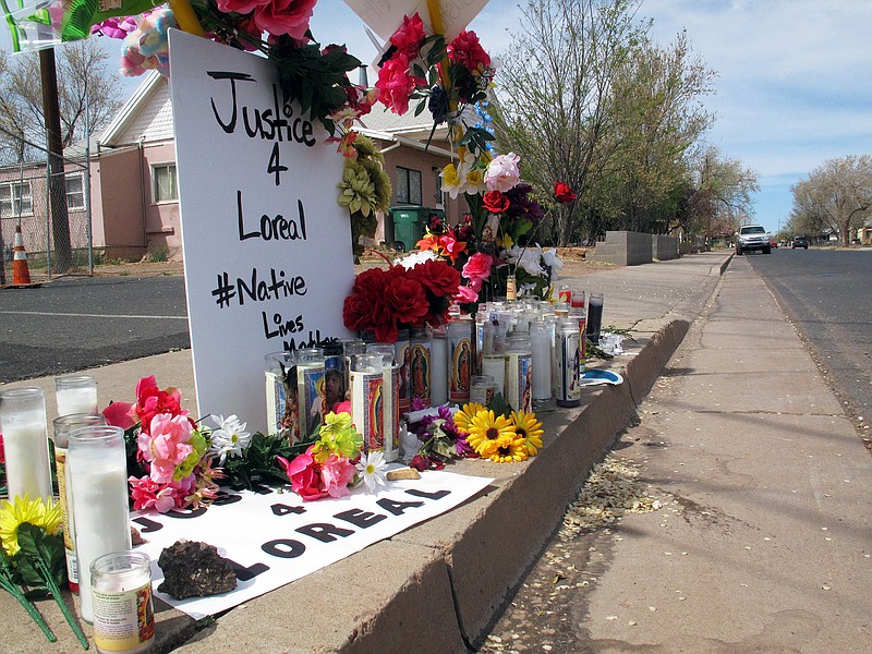 
              FILE - In this Tuesday, April 5, 2016, file photo, candles, flowers and stuffed animals mark the site where Loreal Tsingine was shot and killed by Winslow, Ariz., police officer Austin Shipley on March 27. At least two officers who trained Shipley, who later shot and killed Tsingine, armed with scissors, had serious concerns that he was too quick to go for his service weapon, ignored directives from superiors and falsified reports, according to records obtained by The Associated Press. (AP Photo/Felicia Fonseca, File)
            