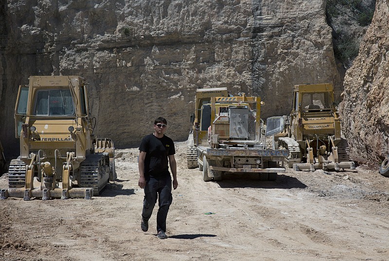 
              In this Tuesday, April 19, 2016 photo, 25 year-old, Alaa Al-Tawil, walks through a Palestinian quarry in the West Bank village of Beit Fajar, Bethlehem. The economic future of the Palestinian town of Beit Fajar looks bleak after Israel's military shut some three dozen quarries and put 3,500 jobs at risk, paralyzing the dominant local industry. (AP Photo/Nasser Nasser)
            