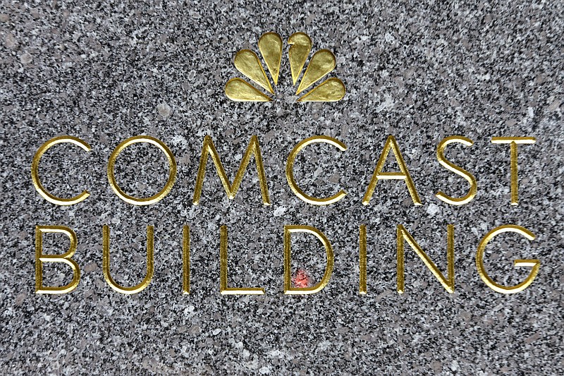 
              FILE - This Thursday, July 23, 2015, file photo, shows the Comcast building sign at Rockefeller Center, in New York. Comcast says later in 2016 you won’t need a cable box to watch cable as the company follows its rivals in offering TV-watching apps. (AP Photo/Mary Altaffer, File)
            