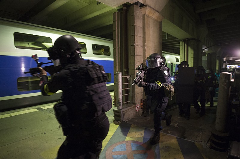 
              Members of the National Gendarmerie Intervention Group (GIGN) take postion during a terror attack exercise at the Gare Montparnasse railway station in Paris, Wednesday, April 20, 2016.  France is reorganizing its police special forces, responding to allegations that rivalries between the three major branches of law enforcement hampered the response to the attacks in November. (Miguel Medina, Pool Photo via AP)
            