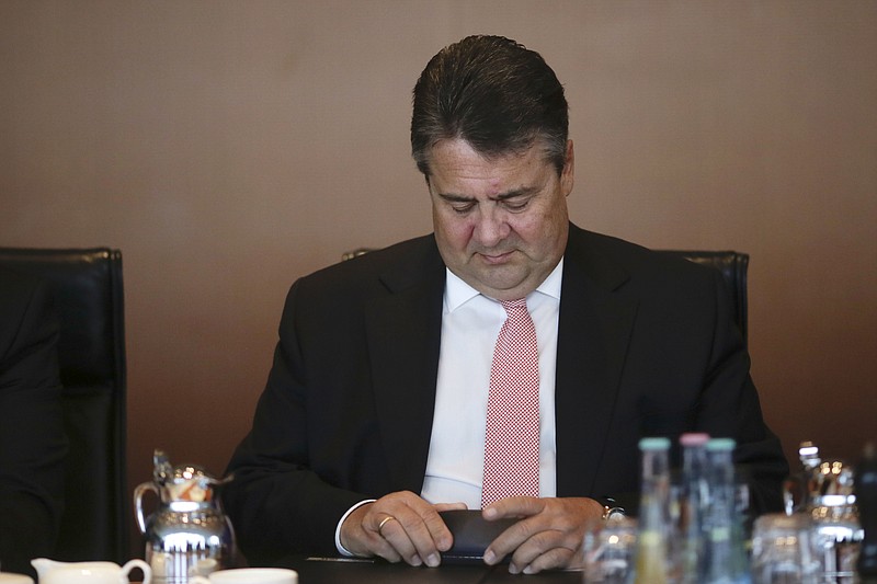 
              German Vice Chancellor and Economy Minister Sigmar Gabriel arrives for the weekly cabinet meeting of the German government at the chancellery in Berlin, Wednesday, April 20, 2016. (AP Photo/Markus Schreiber)
            