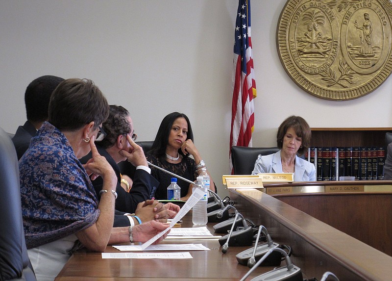 
              South Carolina Rep. Mia McLeod, center, listens to lawmakers discuss her bill requiring a 24-hour waiting period for men to get a Viagra prescription on Wednesday, April 20, 2016, in Columbia, South Carolina. The Columbia Democrat said her bill was a tongue-in-cheek response to all of the regulations South Carolina's male-dominated Legislature places on abortions. (AP Photo/Jeffrey Collins)
            