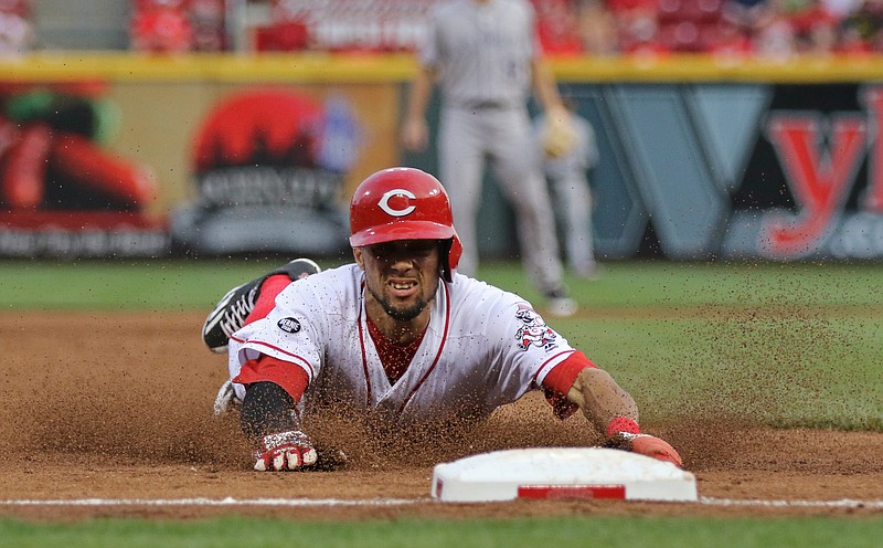 
              Cincinnati Reds' Billy Hamilton slides into third base with a steal against the Colorado Rockies during the second inning of a baseball game, Tuesday, April 19, 2016, in Cincinnati. (AP Photo/Gary Landers)
            