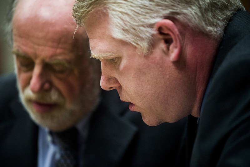 Defense attorney Mark Kriger, left, goes over charges with his client, state Department of Environmental Quality employee Stephen Busch, before an arraignment Wednesday, April 20, 2016, in Flint, Mich. Two state employees facing charges related to the Flint water crisis are accused of refusing to order chemical treatment that could have prevented the release of lead in old plumbing. (Jake May/The Flint Journal-MLive.com via AP)