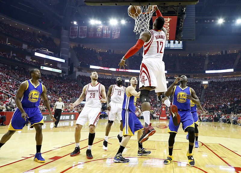 
              Houston Rockets center Dwight Howard scores against the Golden State Warriors during the first half in Game 3 of a first-round NBA basketball playoff series, Thursday, April 21, 2016, in Houston. (AP Photo/David J. Phillip)
            