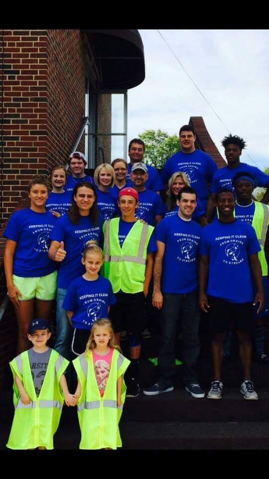 Local citizens take a break from helping with the citywide cleanup effort last year.