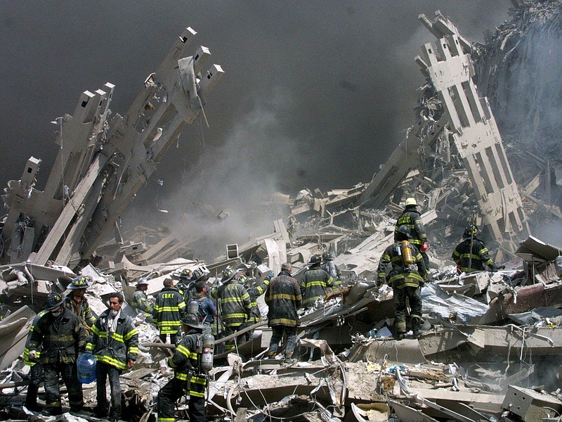 Firefighters make their way through the rubble after two airliners crashed into the World Trade Center in New York bringing down the landmark buildings Tuesday, Sept. 11, 2001.