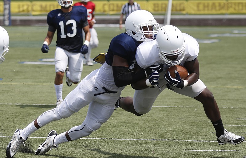 UTC defensive back Tae Davis pushes a player out of bounds during practice. He said he spent the offseason working on making tackles in open space.