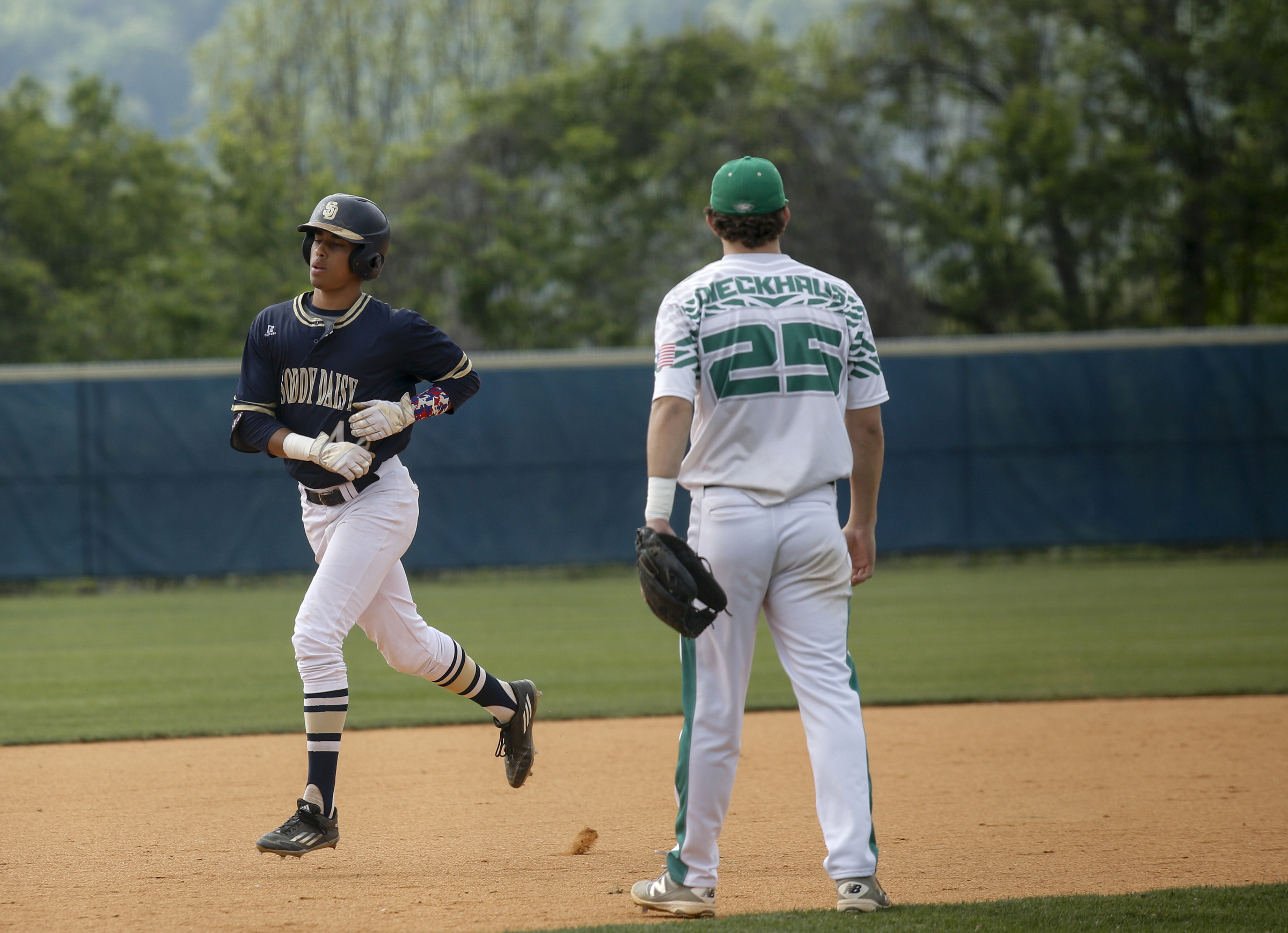 Soddy-Daisy center fielder Tre Carter rounds the bases past Rhea County 3rd baseman Braxton Dieckhaus after hitting his 2nd homer over the center field wall during their prep baseball game at Soddy-Daisy High School on Thursday, April 21, 2016, in Soddy-Daisy, Tenn.