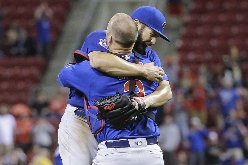 
              Chicago Cubs starting pitcher Jake Arrieta, left, celebrates with catcher David Ross after the final out of his no-hitter in a baseball game against the Cincinnati Reds, Thursday, April 21, 2016, in Cincinnati. The Cubs won 16-0. (AP Photo/John Minchillo)
            