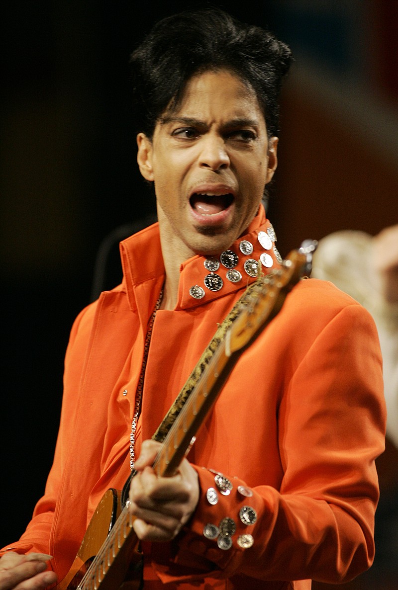 
              FILE - In this Feb. 1, 2007 file photo, Prince plays his guitar during a press conference at the Miami Beach Convention Center in Miami Beach, Fla. Prince's publicist has confirmed that Prince died at his home in Minnesota, Thursday, April 21, 2016. He was 57. (AP Photo/Wilfredo Lee, File)
            