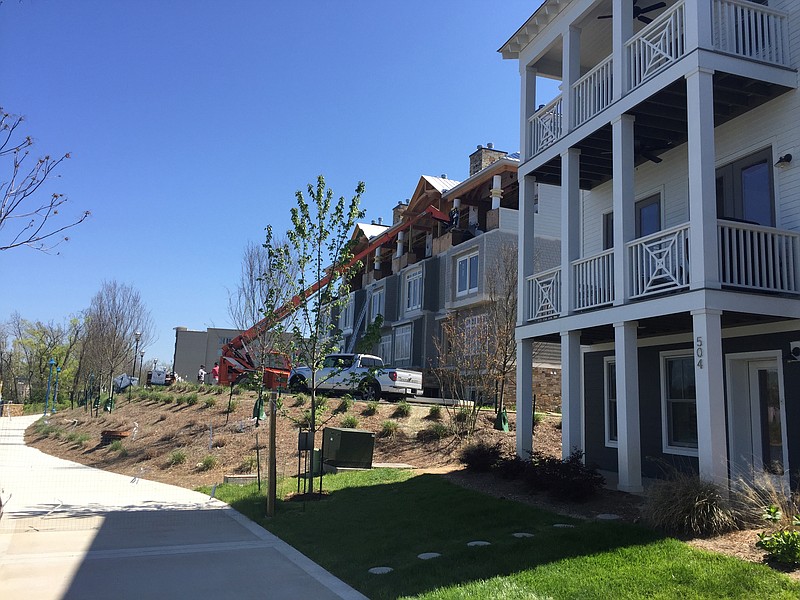 Workers add more homes in the Cameron Harbor development on Chattanooga's downtown waterfront along Riverfront Parkway
