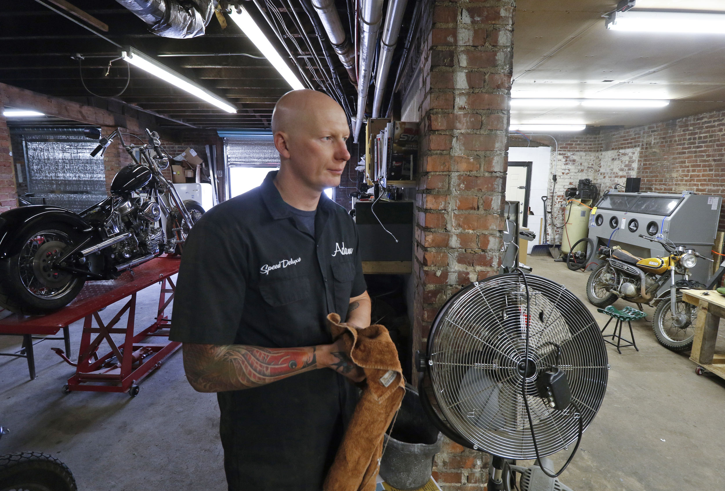 Staff Photo by Dan Henry / The Chattanooga Times Free Press- 3/28/16. Adam Sheard, owner of Speed Deluxe, works on restoring a '72 Honda CB 450 while at his shop's new North Chattanooga location off of Cherokee Boulevard on Monday, March 29, 2016.