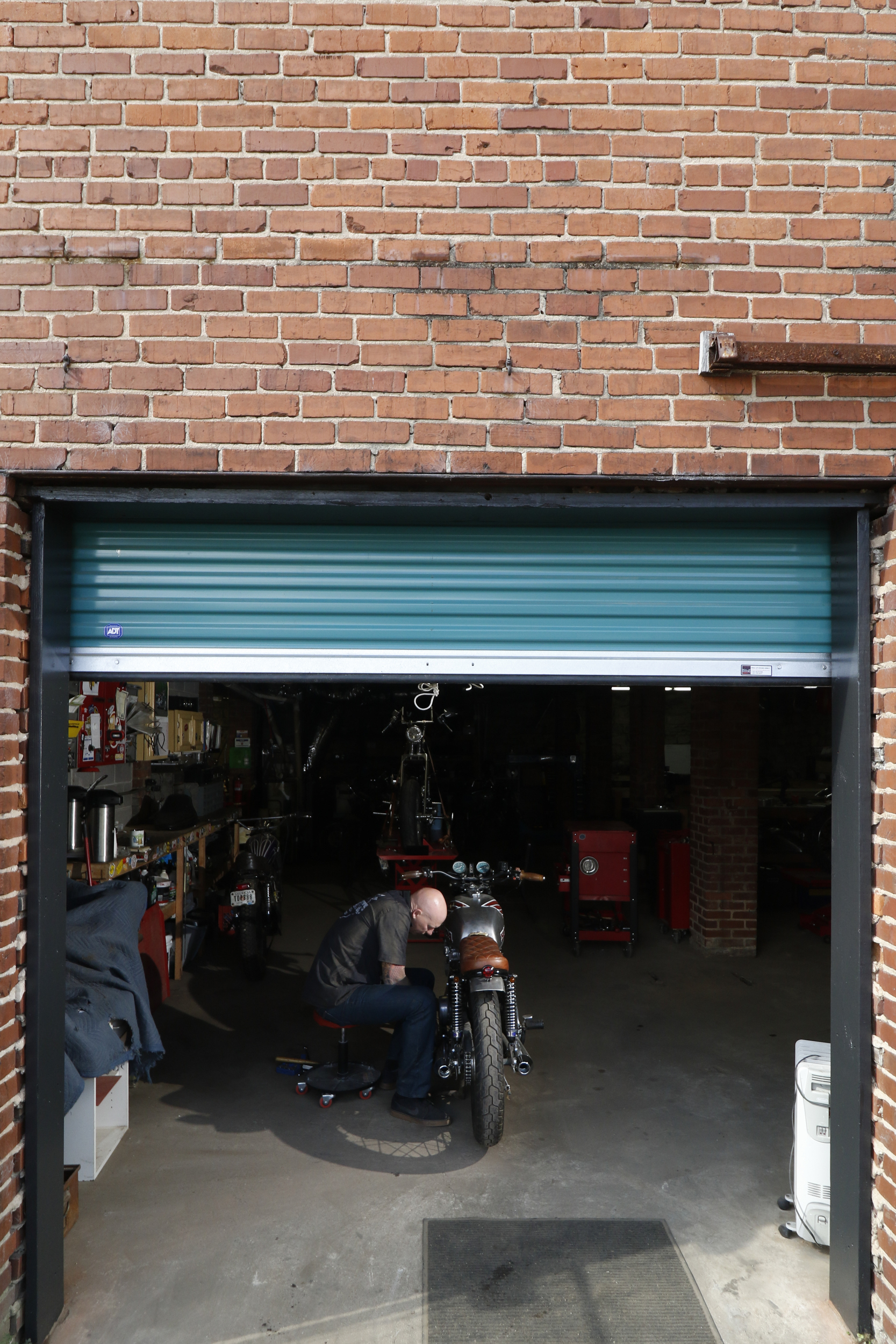Staff Photo by Dan Henry / The Chattanooga Times Free Press- 3/28/16. Adam Sheard, owner of Speed Deluxe, works on restoring a '72 Honda CB 450 while at his shop's new North Chattanooga location off of Cherokee Boulevard on Monday, March 29, 2016.