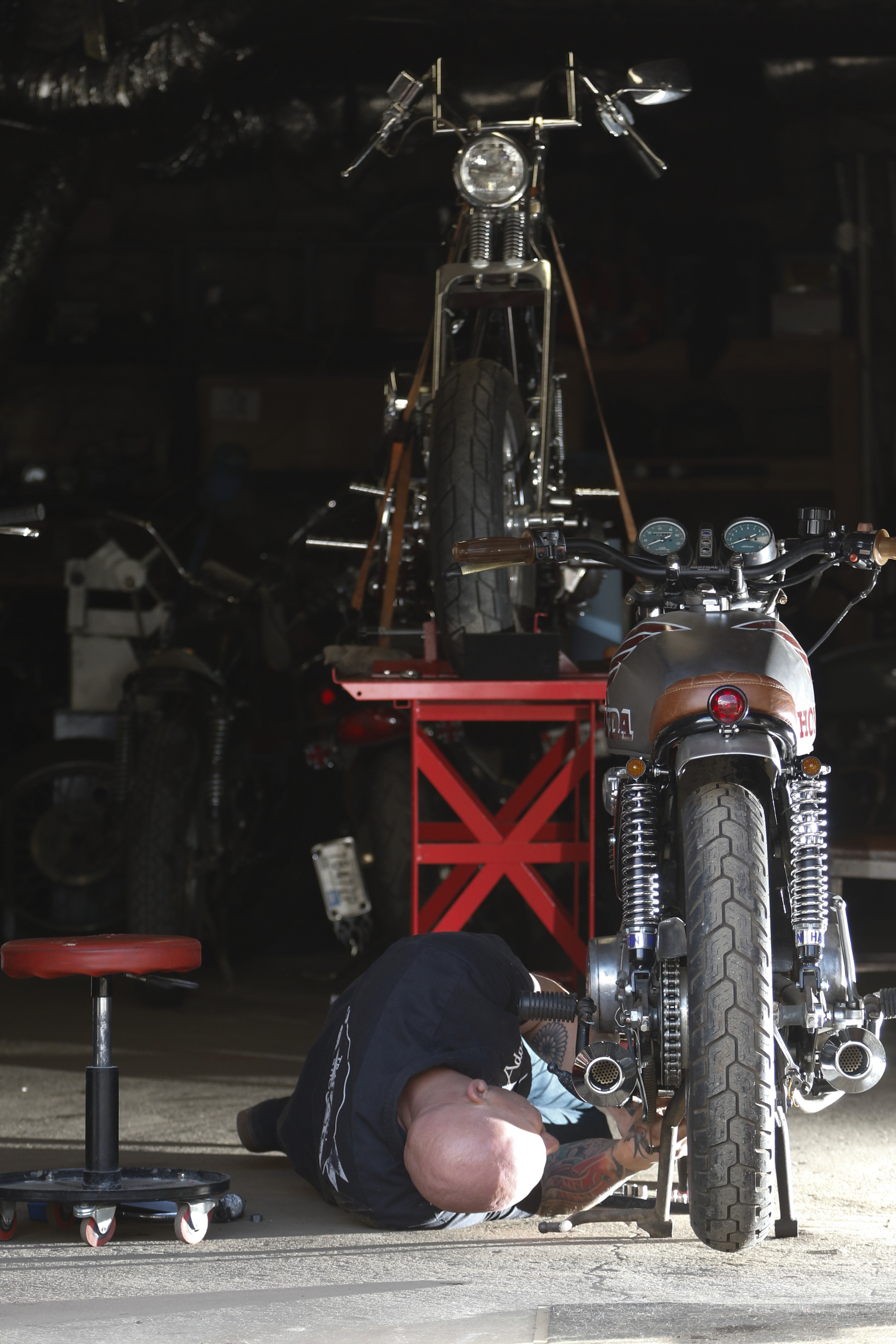 Staff Photo by Dan Henry / The Chattanooga Times Free Press- 3/28/16. Adam Sheard, owner of Speed Deluxe, works on restoring a '72 Honda CB 450 while at his shop's new North Chattanooga location off of Cherokee Boulevard on Monday, March 29, 2016.