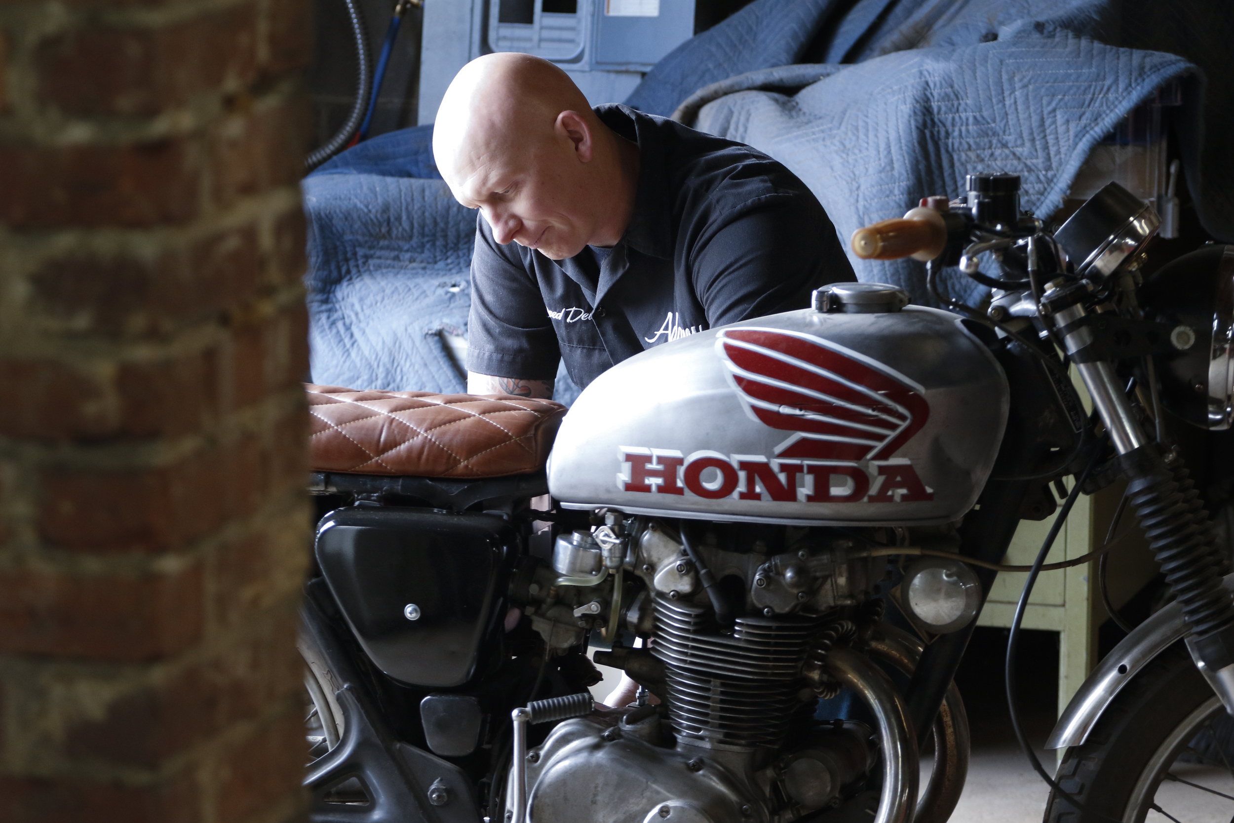 Staff Photo by Dan Henry / The Chattanooga Times Free Press- 3/28/16. Adam Sheard, owner of Speed Deluxe, works on restoring a '72 Honda CB 450 while at his shop's new North Chattanooga location off of Cherokee Boulevard on Monday, March 29, 2016.