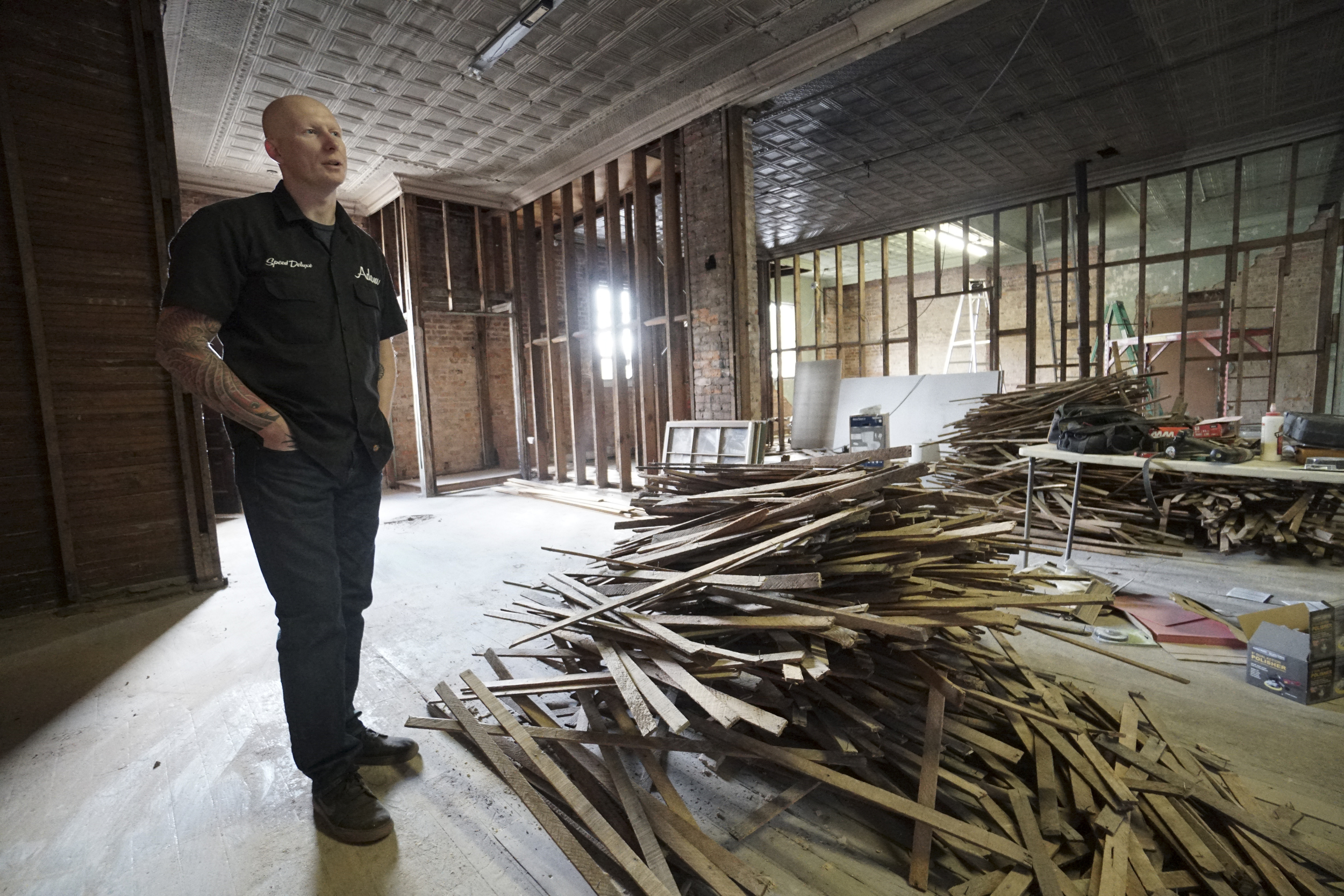 Staff Photo by Dan Henry / The Chattanooga Times Free Press- 3/28/16. Adam Sheard, owner of Speed Deluxe, makes his way upstairs at his shop's new North Chattanooga location off of Cherokee Boulevard on Monday, March 29, 2016.