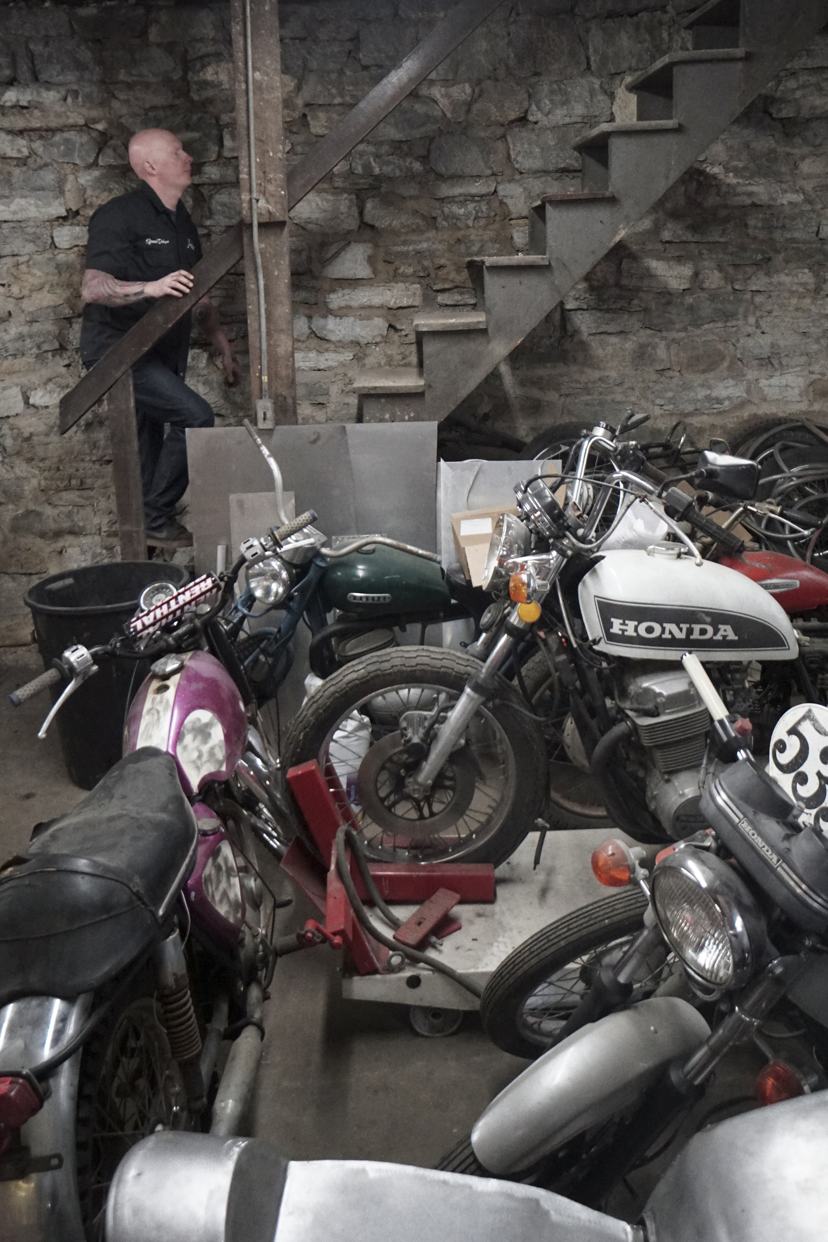 Staff Photo by Dan Henry / The Chattanooga Times Free Press- 3/28/16. Adam Sheard, owner of Speed Deluxe, makes his way upstairs at his shop's new North Chattanooga location off of Cherokee Boulevard on Monday, March 29, 2016.