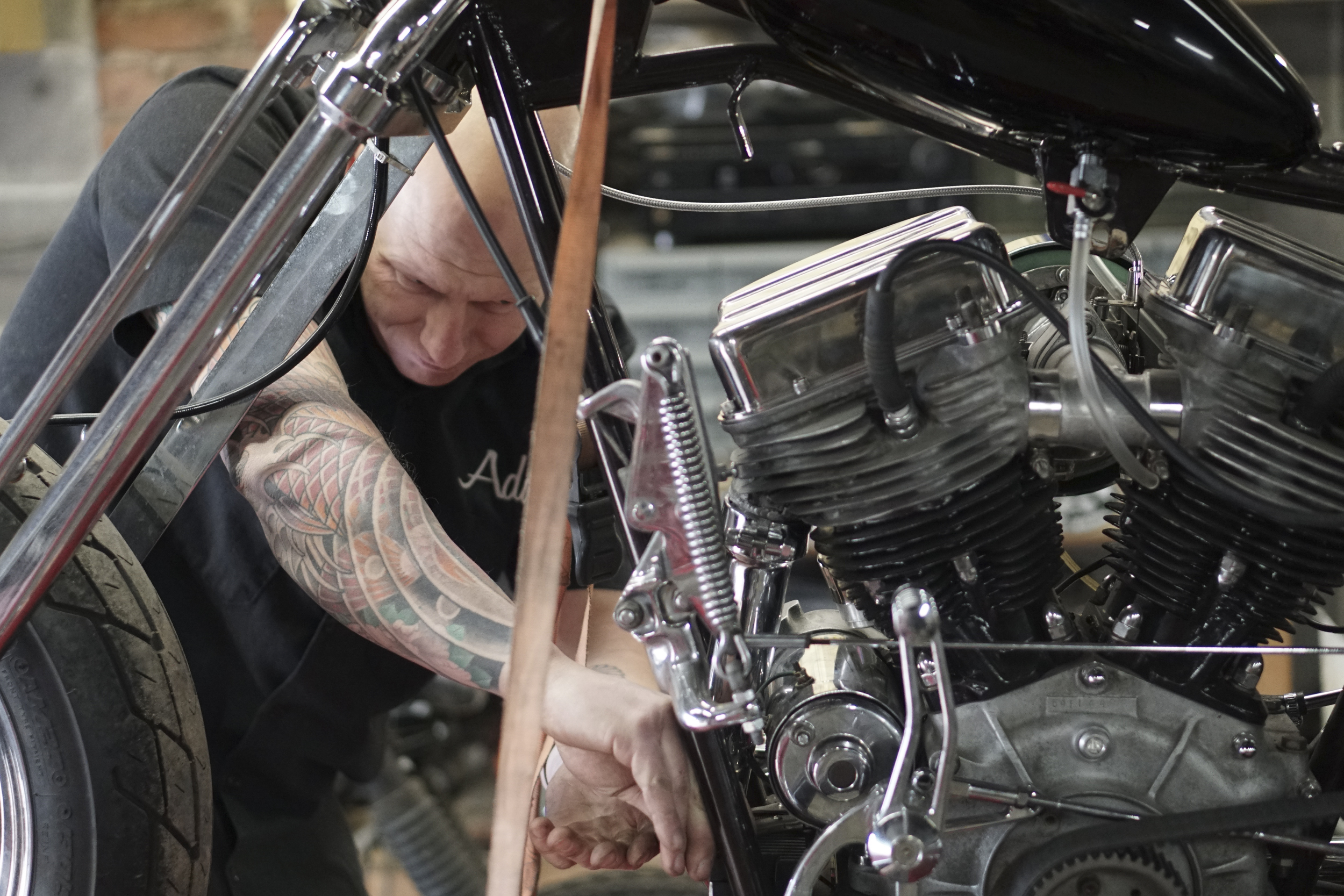 Staff Photo by Dan Henry / The Chattanooga Times Free Press- 3/28/16. Adam Sheard, owner of Speed Deluxe, works on restoring a '54 Pinhead Harley Davidson while at his shops new North Chattanooga location off of Cherokee Boulevard on Monday, March 29, 2016.