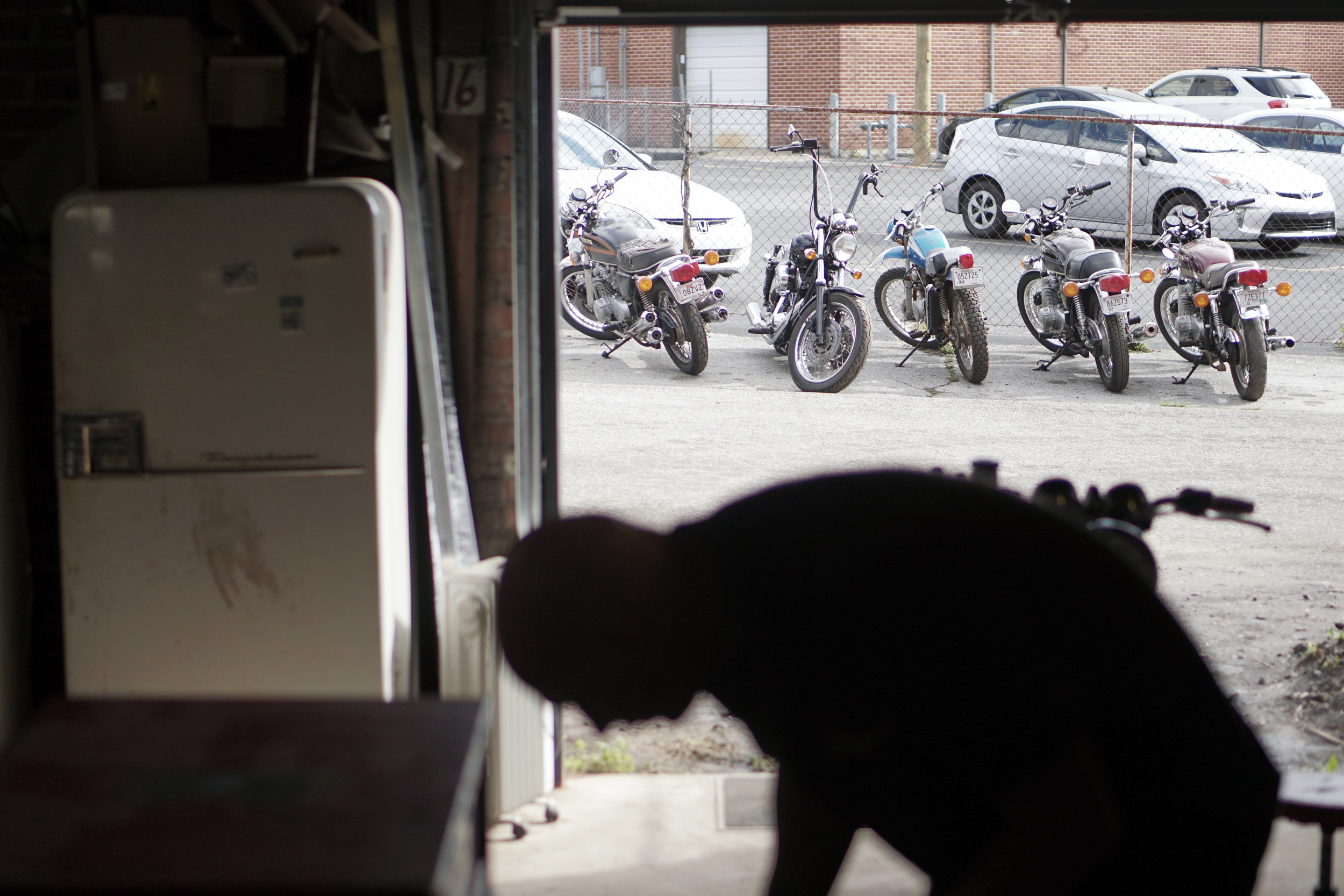 Staff Photo by Dan Henry / The Chattanooga Times Free Press- 3/28/16. Adam Sheard, owner of Speed Deluxe, works on restoring a '54 Pinhead Harley Davidson while at his shops new North Chattanooga location off of Cherokee Boulevard on Monday, March 29, 2016.
