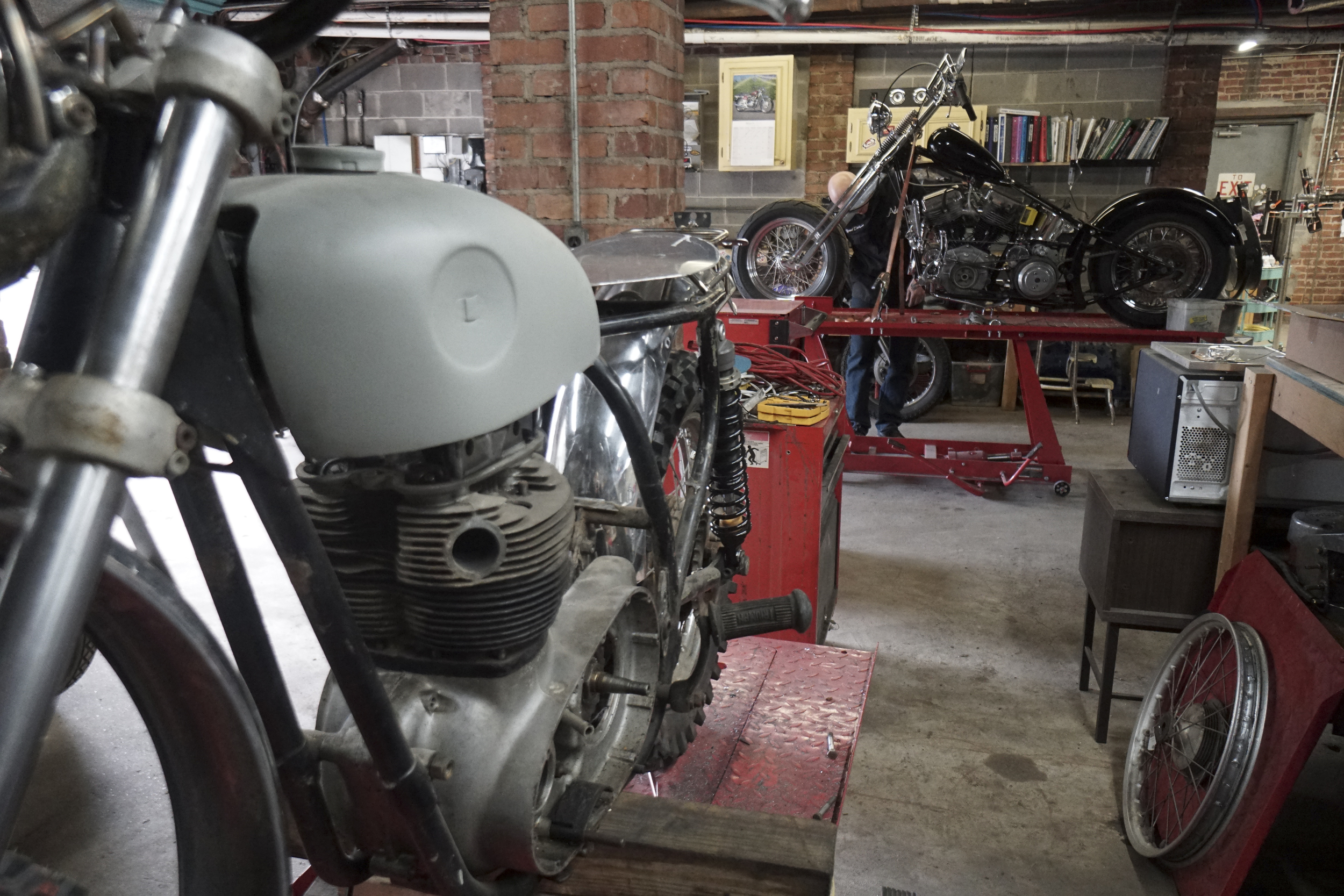 Staff Photo by Dan Henry / The Chattanooga Times Free Press- 3/28/16. Adam Sheard, owner of Speed Deluxe, works on restoring a '54 Pinhead Harley Davidson while at his shops new North Chattanooga location off of Cherokee Boulevard on Monday, March 29, 2016.
