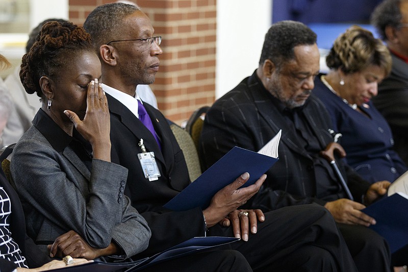 Elizabeth Williams, LaFrederick Thurkill, John Edwards, and Rep. JoAnne Favors, from left, bow their heads in a moment of silence for Ed Johnson at a ceremony in his honor held at Bessie Smith Hall on Friday, April 22, 2016, in Chattanooga, Tenn. The Tennessee House passed a resolution to honor Johnson, who was lynched at the Walnut Street Bridge in 1906.