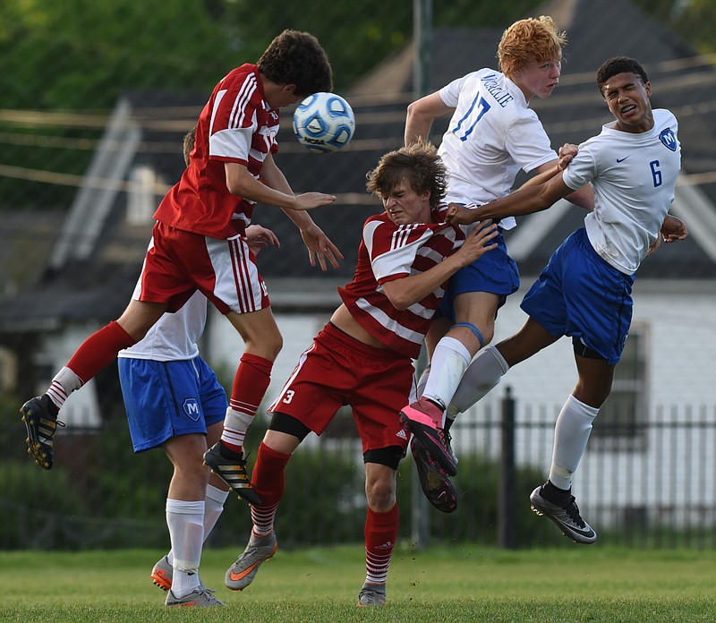 Baylor's John Musick, left, heads the ball as Sam Stewart is pulled into McCallie's Noah Tremain (17) by Stone Roebuck (6) in a hard fought first half of play at McCallie Friday evening.