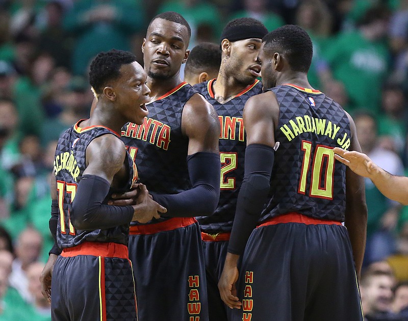 Atlanta Hawks' Dennis Schroeder, left, is pulled away from a scuffle with Boston Celtics' Isaiah Thomas by Paul Millsap and teammates during the first half of Game 3 of an NBA basketball first-round playoff series Friday, April 22, 2016, in Boston. (Curtis Compton/Atlanta Journal Constitution via AP)