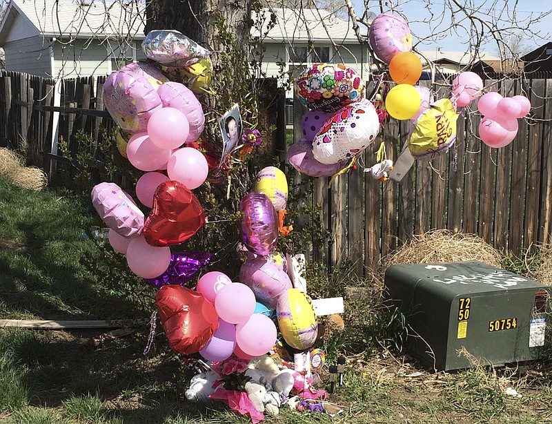 
              A memorial is placed in front of the house for 1-year-old Kenzley Olson on Friday, April 22, 2016, in Poplar, Mont. A federal investigator says a woman beat to death the girl on a Montana Indian reservation and threw the baby's body into a dumpster. Janelle Red Dog appeared in Fort Peck Tribal Court on Friday in the death of Olson after she reportedly confessed and drew a map of where the body was located. (AP Photo/Richard Peterson)
            