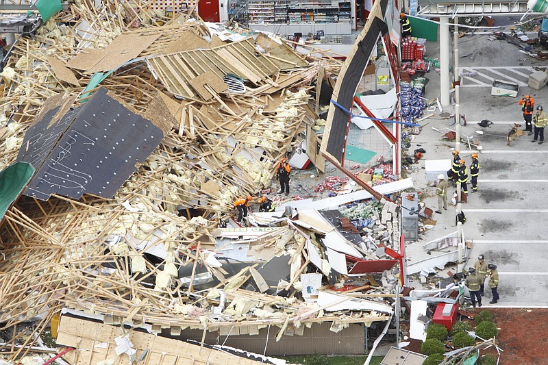 Emergency personnel perform search-and-rescue efforts at the former BP gas station in downtown Ringgold, Ga., on April 28, 2011, after a tornado touched down.
