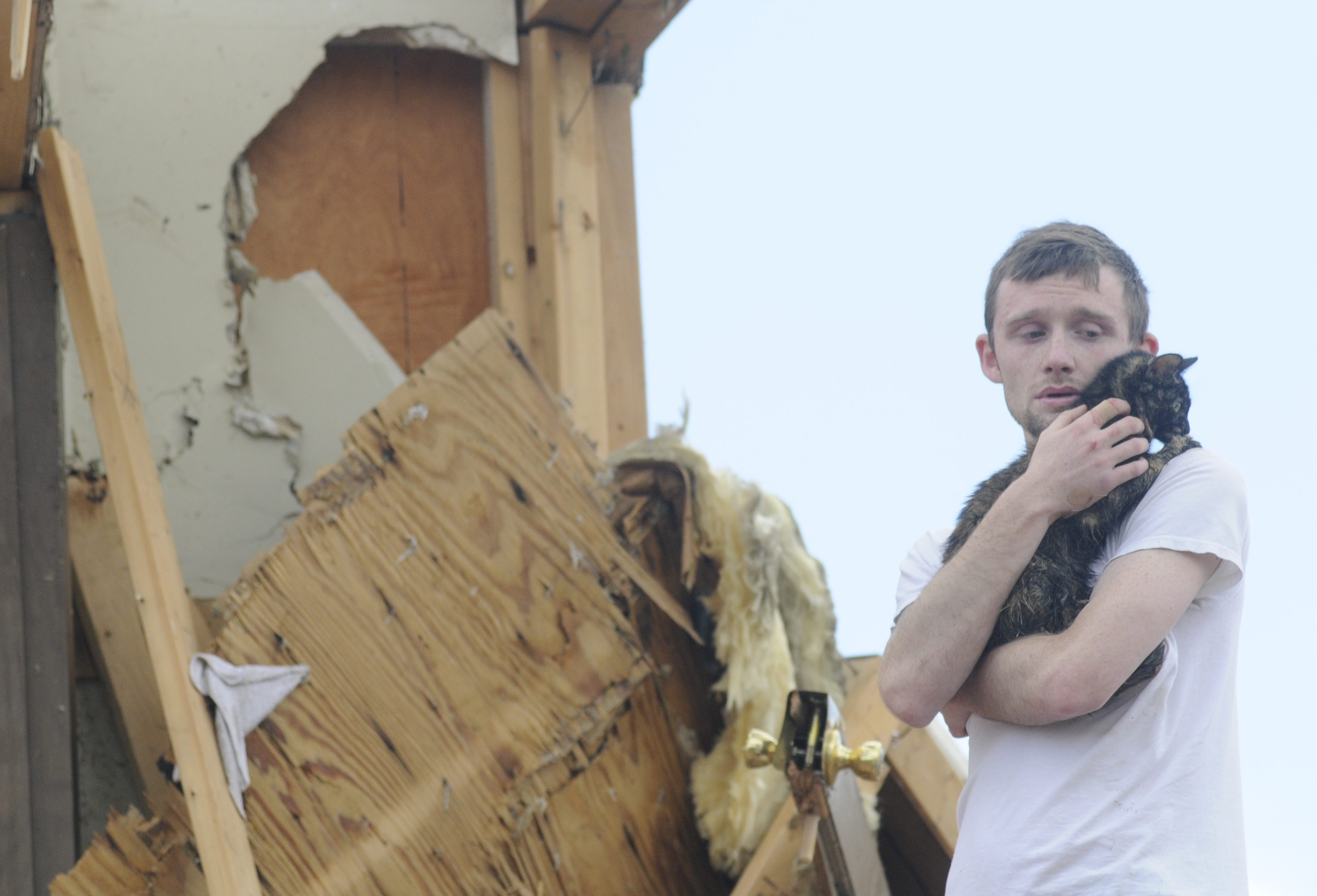 Andy Page holds Ellie on April 28, 2011, after locating her in what used to be his Village Green apartment in Trenton, Ga. Page managed to get some of his cats out, but could not find Ellie after his apartment was destroyed by a tornado.