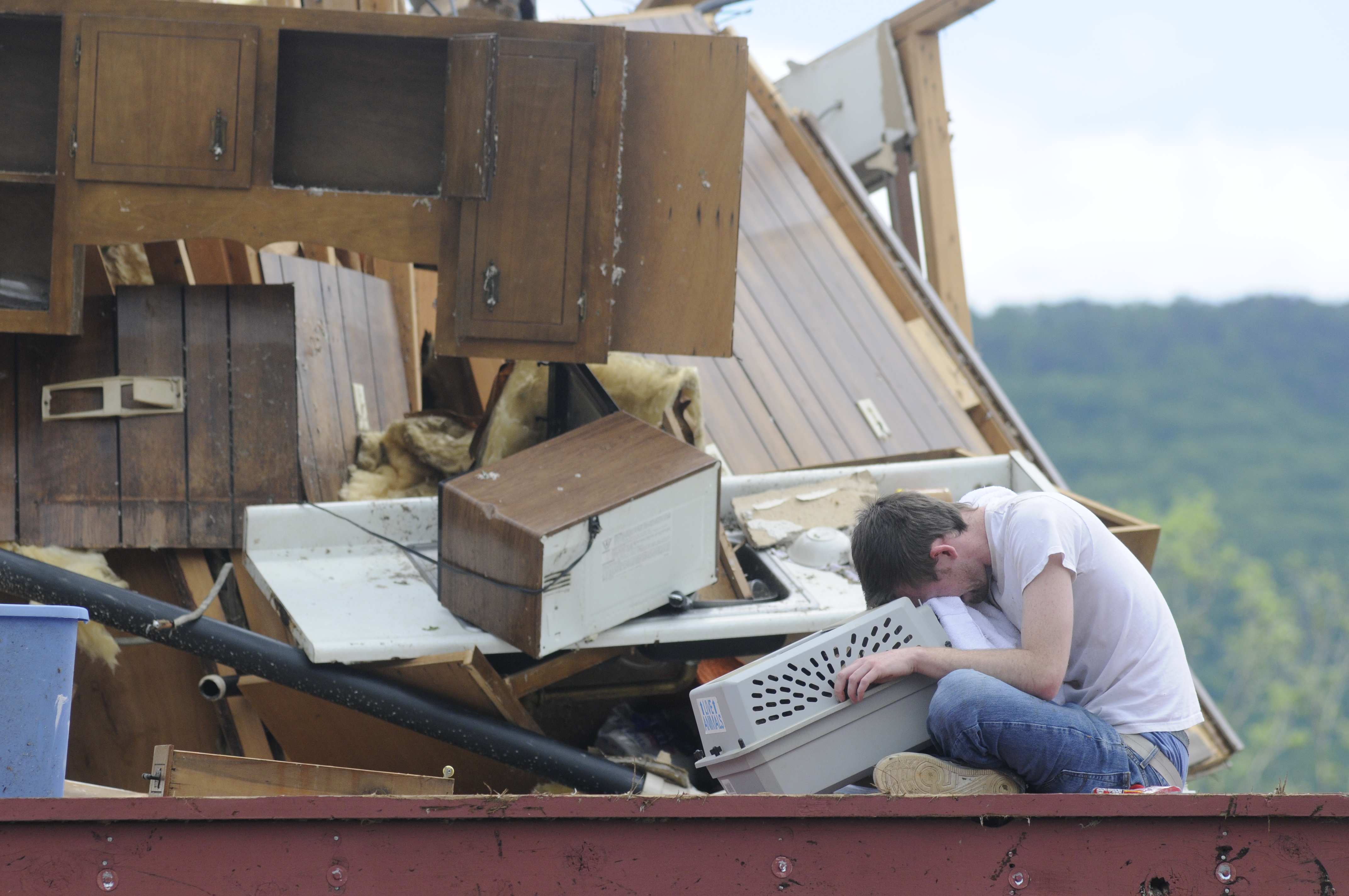 Andy Page holds his pet carrier on April 28, 2011, after locating his cat in what used to be his Village Green apartment in Trenton, Ga. Page managed to get some of his cats out, but could not find Ellie after his apartment was destroyed by a tornado.