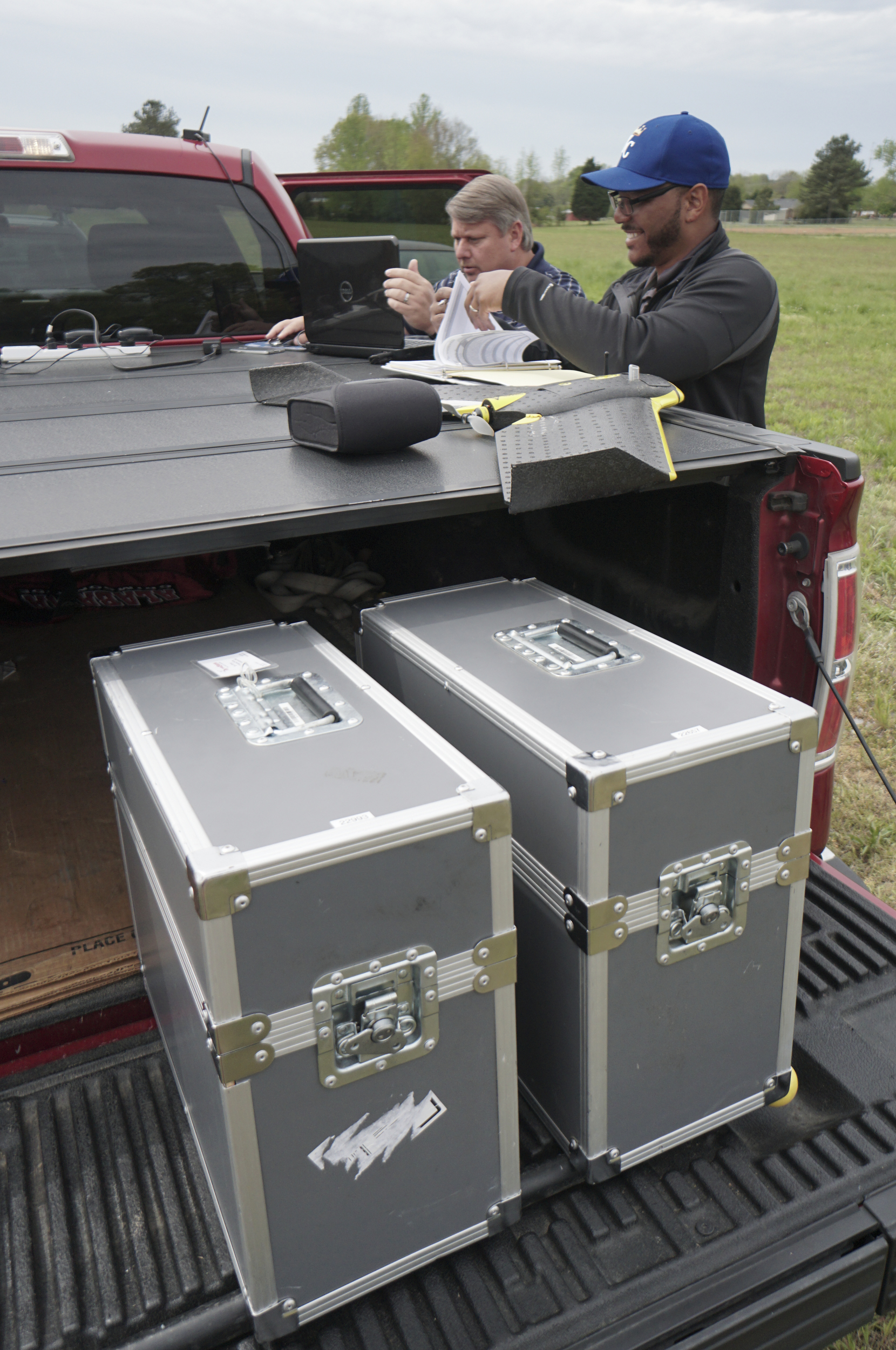 Staff Photo by Dan Henry / The Chattanooga Times Free Press- 4/13/16. Mark Warner, left, and Ken Harvey with "enrGies Operations", prepare to fly a fixed wing autonomous drone on Wednesday, April 13, 2016 to photograph damage patterns from a tornado that formed two weeks ago near Priceville, Alabama. The team is working in conjunction with the Southeast Vortex Campaign in performing research to support a hypothesis that surface friction and topography play a role in the formation of tornadoes.