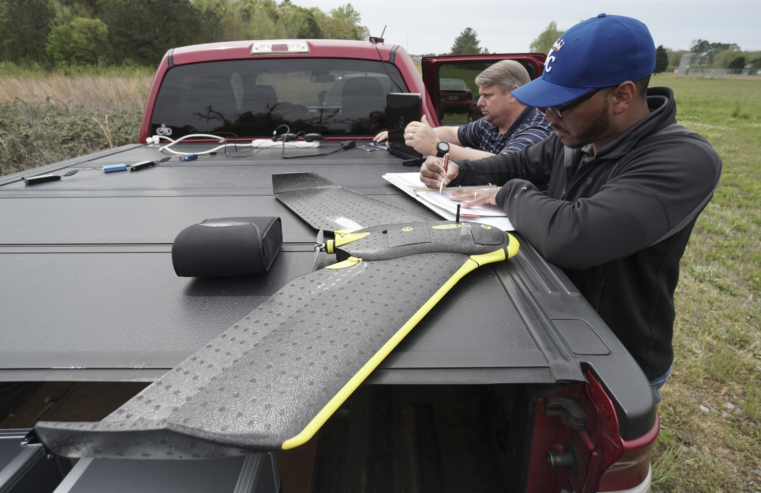 Staff Photo by Dan Henry / The Chattanooga Times Free Press- 4/13/16. Mark Warner, left, and Ken Harvey with "enrGies Operations", prepare to fly a fixed wing autonomous drone on Wednesday, April 13, 2016 to photograph damage patterns from a tornado that formed two weeks ago near Priceville, Alabama. The team is working in conjunction with the Southeast Vortex Campaign in performing research to support a hypothesis that surface friction and topography play a role in the formation of tornadoes.
