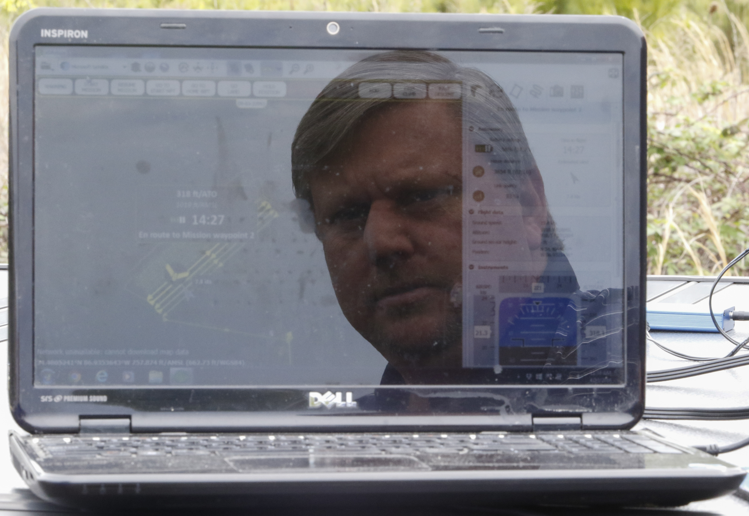 Staff Photo by Dan Henry / The Chattanooga Times Free Press- 4/13/16. Mark Warner with "enrGies Operations" uses a computer to check the status of a fixed wing autonomous drone he is flying on Wednesday, April 13, 2016 to photograph damage patterns from a tornado that formed two weeks ago near Priceville, Alabama. The team is working in conjunction with the Southeast Vortex Campaign in performing research to support a hypothesis that surface friction and topography play a role in the formation of tornadoes.