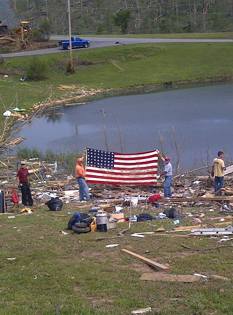 Len Williams, left, and Clint Wilkie, right, volunteers
with Covenant Presbyterian Church in East Brainerd, hold up an American flag
they found during recent storm cleanup efforts. The flag had draped the
casket of Catoosa County Tax Commissioner Sandra Self's grandfather, World
War I veteran Floyd A. Connolly, in 1954.