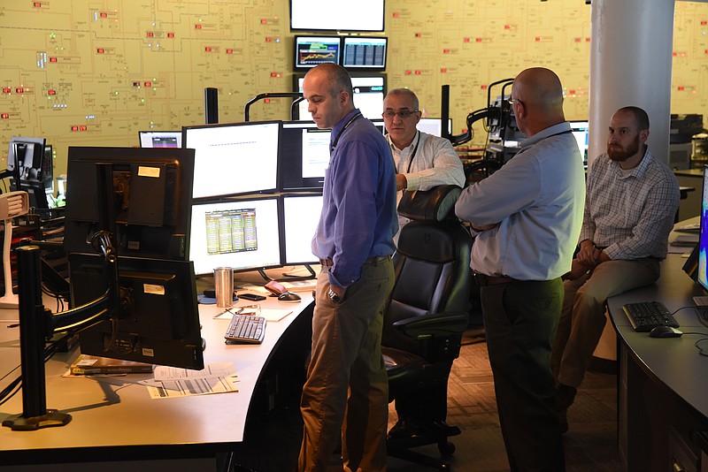 TVA employee's Jason Baggett, left, Chris Thompson, Dewayne Scott and Heath Moore watch readings at the Senior Transmission Operator desk Friday in the power operations center in downtown Chattanooga.