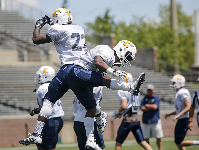 UTC football players celebrate during Saturday's Blue-White spring game at Finley Stadium. With spring practices behind them, the Mocs will focus on bonding and individual improvement over the summer.