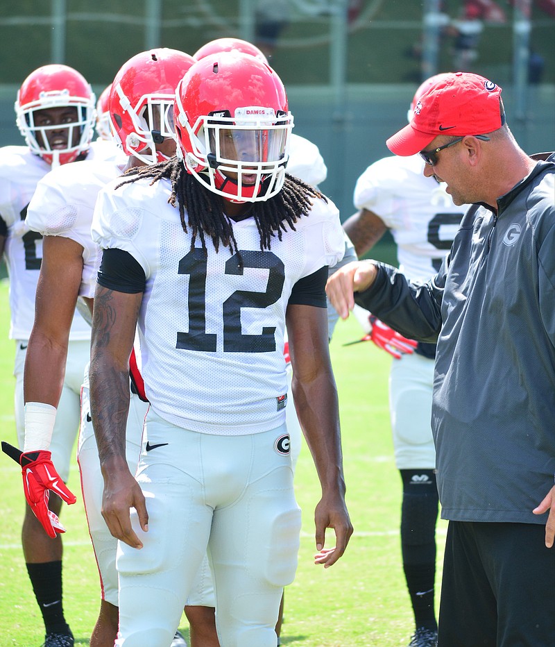 Georgia cornerback Juwuan Briscoe, shown here with former defensive coordinator Jeremy Pruitt last year, was arrested Saturday night in Athens on two traffic-related misdemeanors.