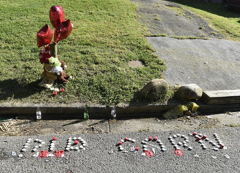 A memorial for a person shot to death around 1 a.m. is seen on Carosel Road on Sunday, Apr. 24, 2016, in Chattanooga, Tenn. 