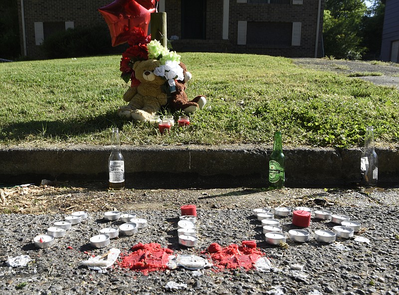 A memorial for a person shot to death around 1 a.m. is seen on Carosel Road on Sunday, Apr. 24, 2016, in Chattanooga, Tenn. 