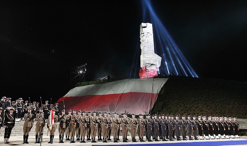 
              FILE - The May 8, 2015 file photo shows Polish Navy troops standing at the foot of the monument to Polish defenders of the Westerplatte peninsula, where some of World War II's first shots were fired, during ceremonies marking the 70th anniversary of the end of the war in Gdansk, Poland. A museum under creation for the past eight years, the Museum of the Second World War, was due to open in Gdansk in 2017 but its fate is threatened by the country's new nationalistic government. The government objects to its international approach and prefers a project that would focus exclusively on Westerplatte and the Polish military defense against Germany in 1939. (AP Photo/Czarek Sokolowski, file)
            