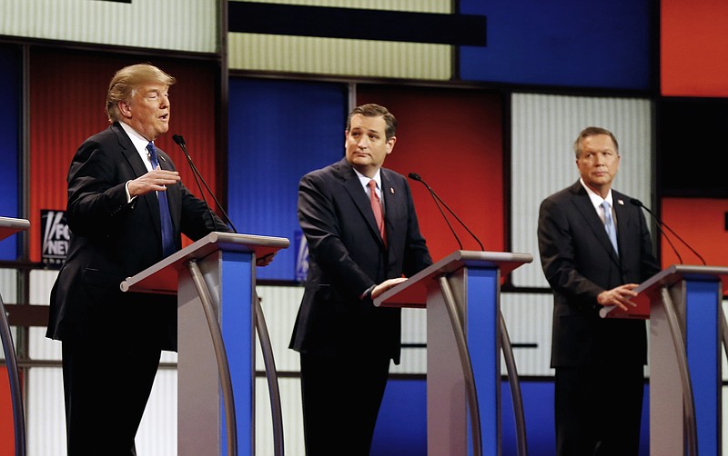 In this March 3, 2016 file photo, Republican presidential candidates, businessman Donald Trump, Sen. Ted Cruz, R-Texas, and Ohio Gov. John Kasich appear during a Republican presidential primary debate at the Fox Theatre in Detroit. Michigan Republicans meet Saturday, April 9, in Lansing for their annual convention with one of the main agenda items the choosing of delegates to the party's presidential convention in July in Cleveland. (AP Photo/Paul Sancya)