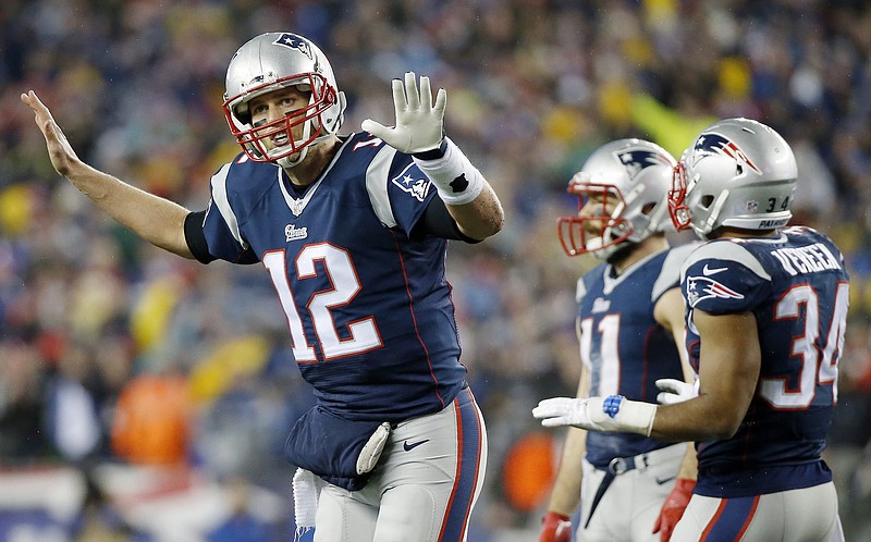 New England Patriots quarterback Tom Brady talks to his teammates during the first half of the NFL football AFC Championship game against the Indianapolis Colts on Sunday, Jan. 18, 2015, in Foxborough, Mass.