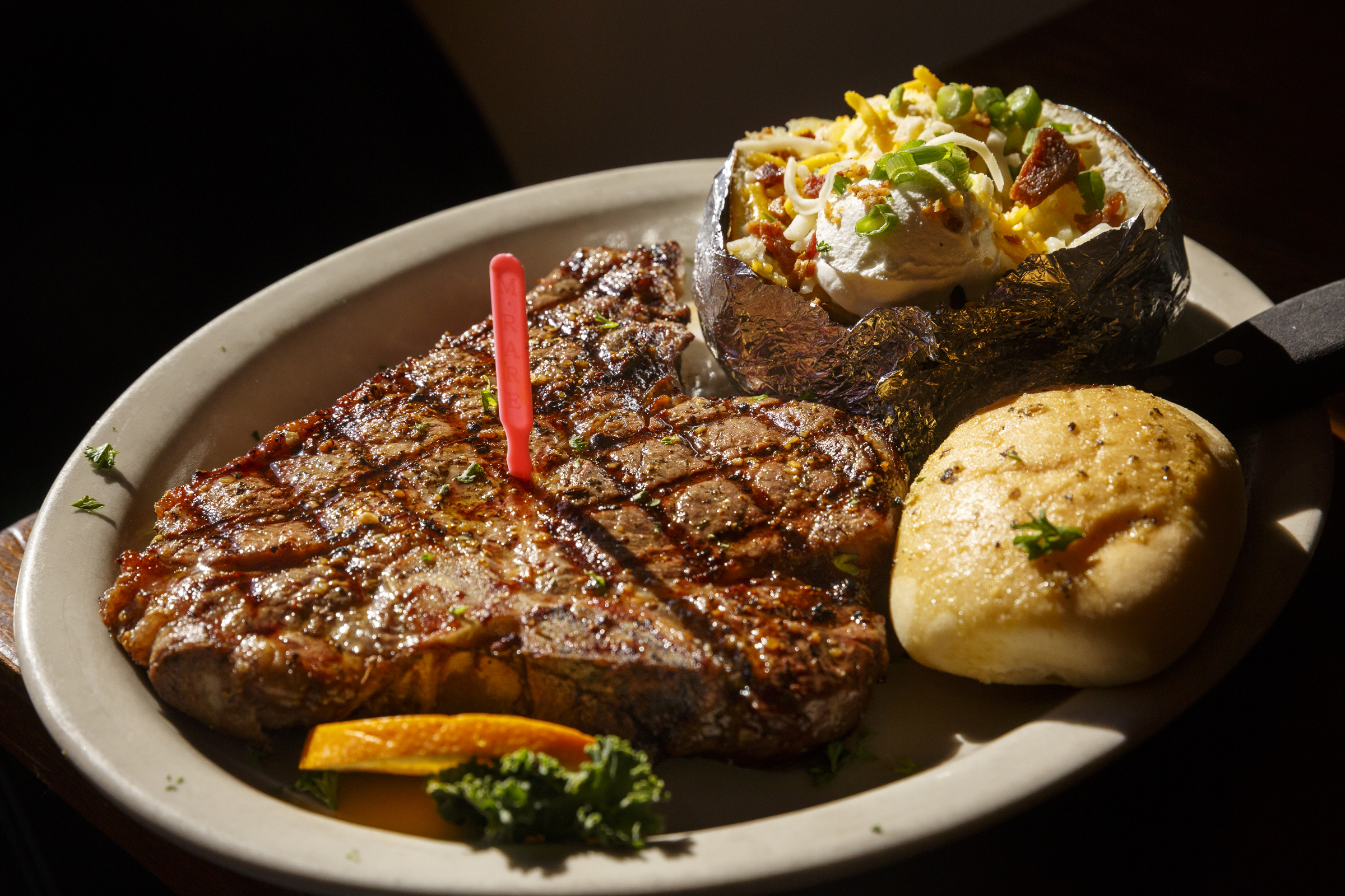 A 20 oz. porterhouse steak with baked potato and dinner role is a signature item at Jacob Myers Restaurant on the Water on Friday, April 15, 2016, in Dayton, Tenn.